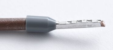 Wire ferrule crimped onto a stranded conductor
